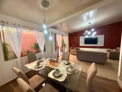 a dining room and living room with a table and chairs at Beautiful and Remodeled House Metropolis S Gabriel in Nejapa