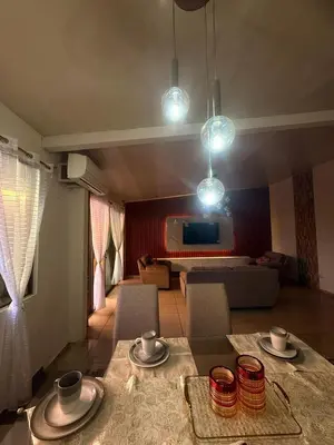 a living room with a table and chairs and a couch at Beautiful and Remodeled House Metropolis S Gabriel in Nejapa