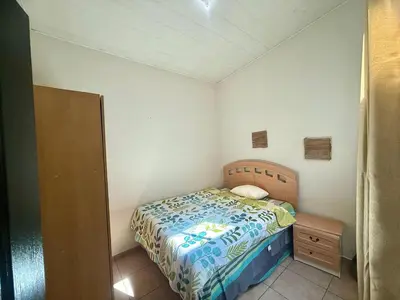 a small bedroom with a bed and a night stand at Beautiful and Remodeled House Metropolis S Gabriel in Nejapa