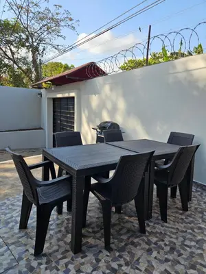 a black table and chairs on a patio at La Casita Cruz in Caluco