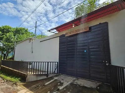 a large black garage door with a sign on it at La Casita Cruz in Caluco