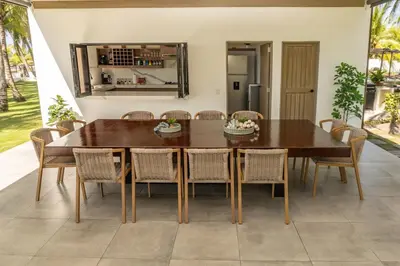 a dining room with a wooden table and chairs at Marcinco in Sonsonate