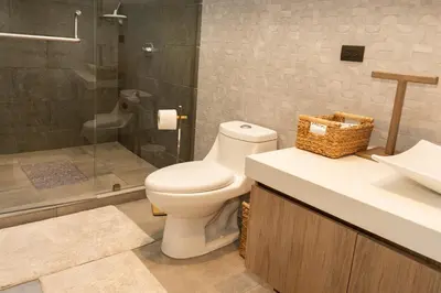 a bathroom with a toilet and a sink and a shower at Marcinco in Sonsonate