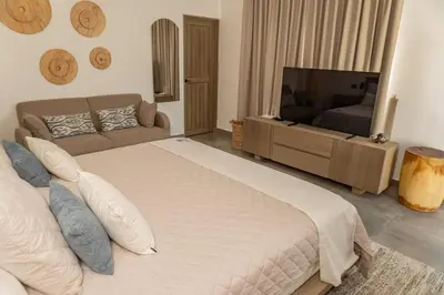 a bedroom with a large bed and a television at Marcinco in Sonsonate