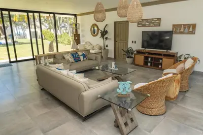 a living room with a couch and chairs and a television at Marcinco in Sonsonate