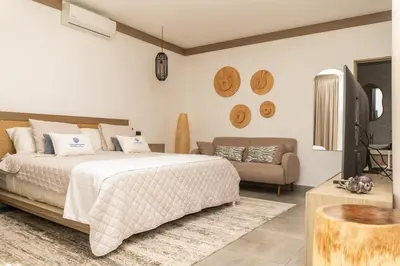 a bedroom with a bed and a couch at Marcinco in Sonsonate