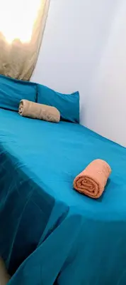a blue bed with a brown pillow on it at Casa de Reyes ll in San Miguel