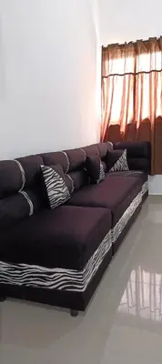 a brown couch in a room with a window at Casa de Reyes ll in San Miguel