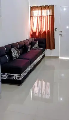 a couch sitting in a living room with a window at Casa de Reyes ll in San Miguel