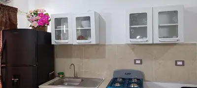 a kitchen with a sink and a refrigerator at Casa de Reyes ll in San Miguel