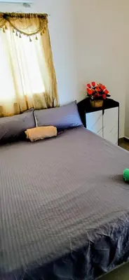 a bedroom with a bed and a window with red flowers at Casa de Reyes ll in San Miguel