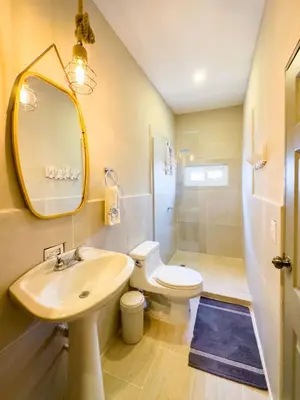 a bathroom with a sink and a toilet and a mirror at Boa Mare in Nanastepeque