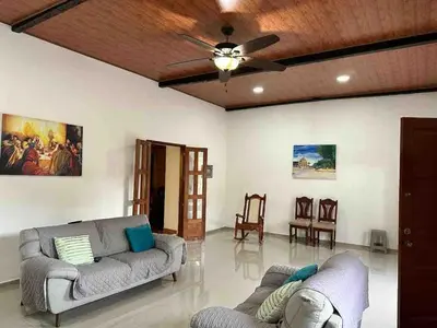 a living room with two couches and a ceiling fan at Modern colonial house