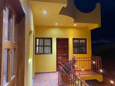 a room with a yellow wall and a staircase at Modern colonial house
