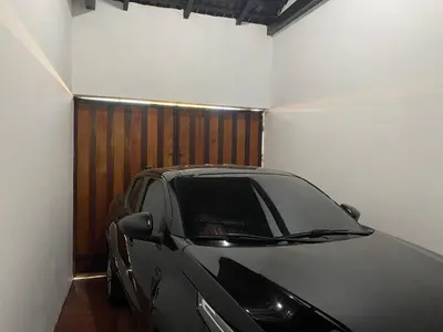 a car parked in a garage next to a wall at Modern colonial house