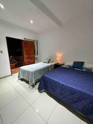 a bedroom with two beds and a window at Modern colonial house
