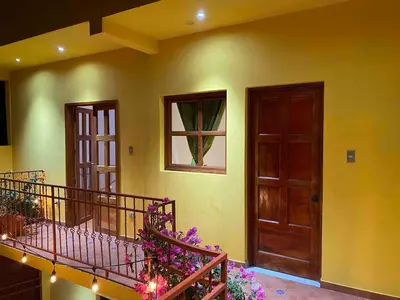 a room with two stairs and a door and flowers at Modern colonial house