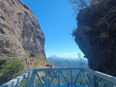 a blue bridge in a canyon between two mountains at habitación doble amueblada baño privado in San Salvador