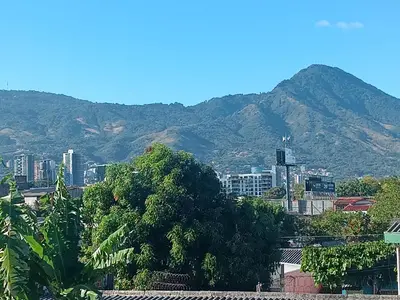 a view of a city with a mountain in the background at habitación doble amueblada baño privado in San Salvador