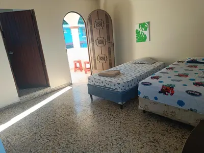 a bedroom with two beds and an open door at habitación doble amueblada baño privado in San Salvador