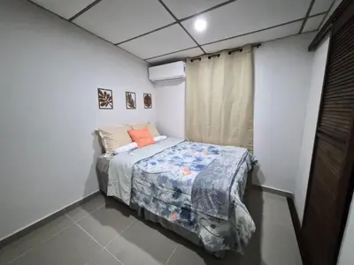a bedroom with a bed in a white room at Ciudad Merliot, casa Don Pablo in Hacienda Plan de La Laguna