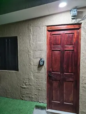 a red door on the side of a building at Ciudad Merliot, casa Don Pablo in Hacienda Plan de La Laguna