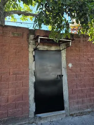 a black door on a brick wall with a brick wall at Ciudad Merliot, casa Don Pablo in Hacienda Plan de La Laguna