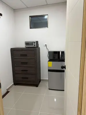 a small kitchen with a microwave and a refrigerator at Ciudad Merliot, casa Don Pablo in Hacienda Plan de La Laguna
