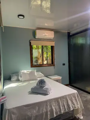 a bedroom with a bed with a towel on it at El Mangal del Zonte in El Zonte