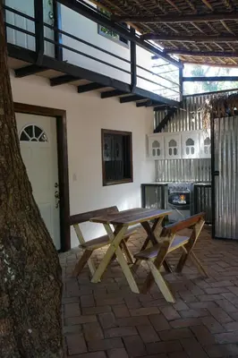 a picnic table and a bench in a patio at El Mangal del Zonte in El Zonte