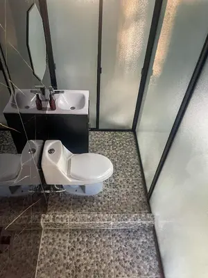 a bathroom with a toilet and a sink at El Mangal del Zonte in El Zonte