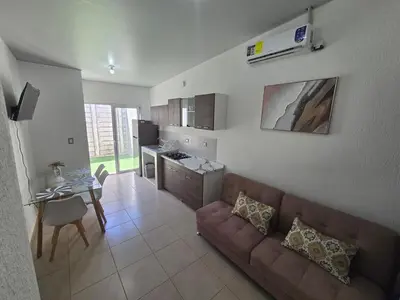 a living room with a couch and a table at Candy House Marsella in Sitio Grande