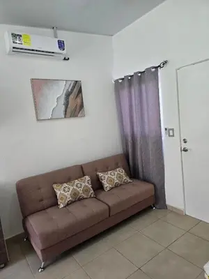 a brown couch in a living room with a window at Candy House Marsella in Sitio Grande
