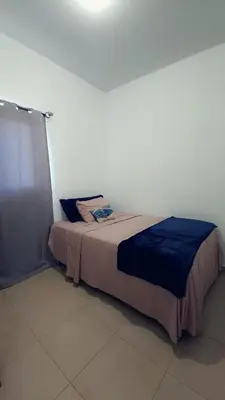 a bedroom with a bed in a white room at Candy House Marsella in Sitio Grande