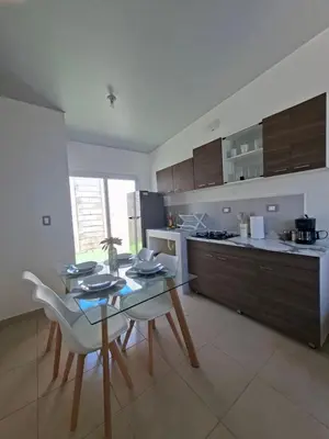 a kitchen with a table and chairs in a kitchen at Candy House Marsella in Sitio Grande
