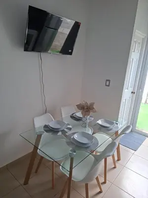a dining room with a glass table and chairs at Candy House Marsella in Sitio Grande