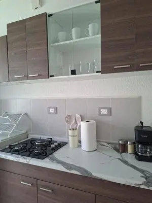 a kitchen with a stove and a counter top at Candy House Marsella in Sitio Grande