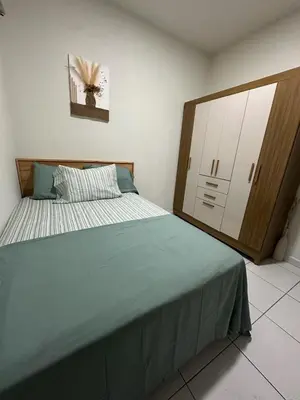 a bedroom with a large bed and a dresser at Apartment D Fuertevali in San Salvador