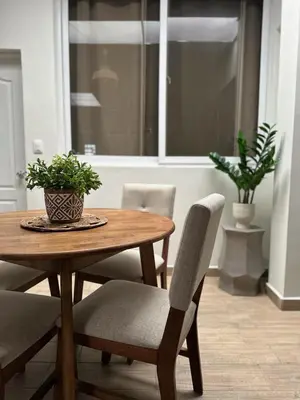 a wooden table and chairs with a plant on it at Apartment D Fuertevali in San Salvador