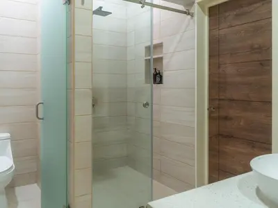 a shower with a glass door in a bathroom at Miradora House in El Sunzal