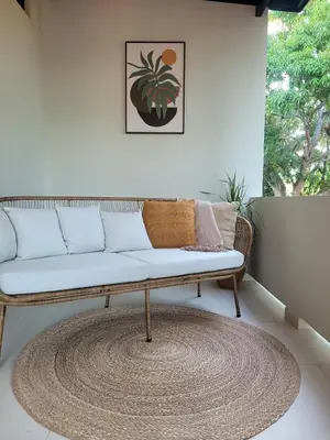 a couch in a living room with a rug at Miradora House in El Sunzal