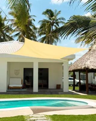 a villa with a swimming pool and a house at Azul Beach House in La Esmeralda