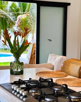 a stove top oven sitting on a table with a vase at Azul Beach House in La Esmeralda