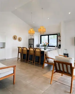 a kitchen and living room with a table and chairs at Azul Beach House in La Esmeralda