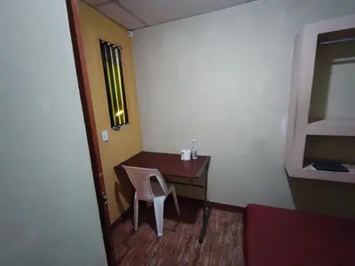 a small room with a desk and a chair at Rooms libertad in San Salvador