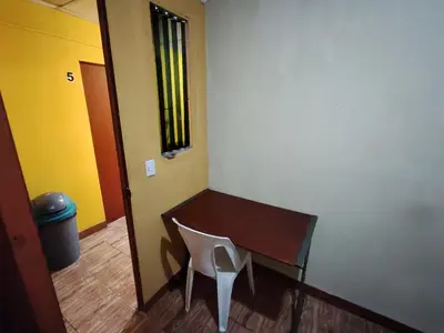a chair sitting next to a desk in a room at Rooms libertad in San Salvador