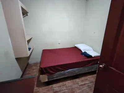 a small bedroom with a small bed in a room at Rooms libertad in San Salvador