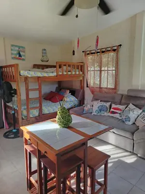 a living room with a couch and a table at La Casita de la Playa La Bocana San Juan in Metalío