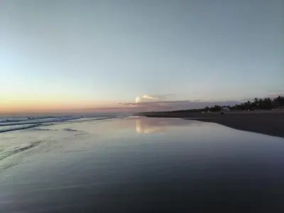 a view of the beach at sunset at La Casita de la Playa La Bocana San Juan in Metalío
