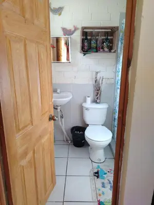 a bathroom with a toilet and a sink at La Casita de la Playa La Bocana San Juan in Metalío
